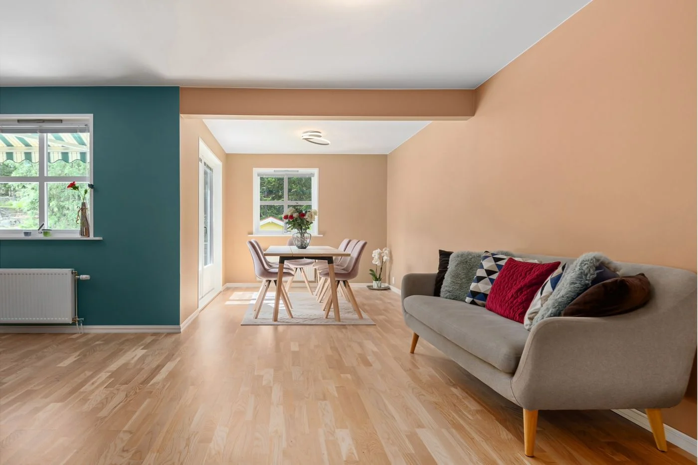 Sofa beside a dining area in a narrow living space