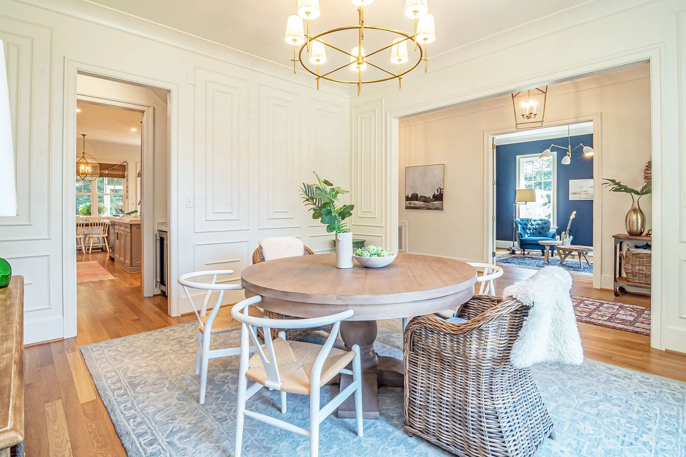 Round dining table with chairs beside windows