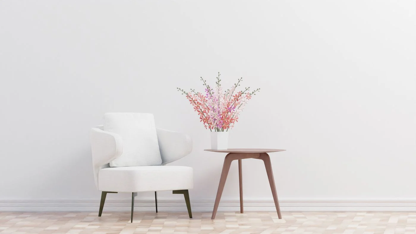 White armchair beside a wooden side table