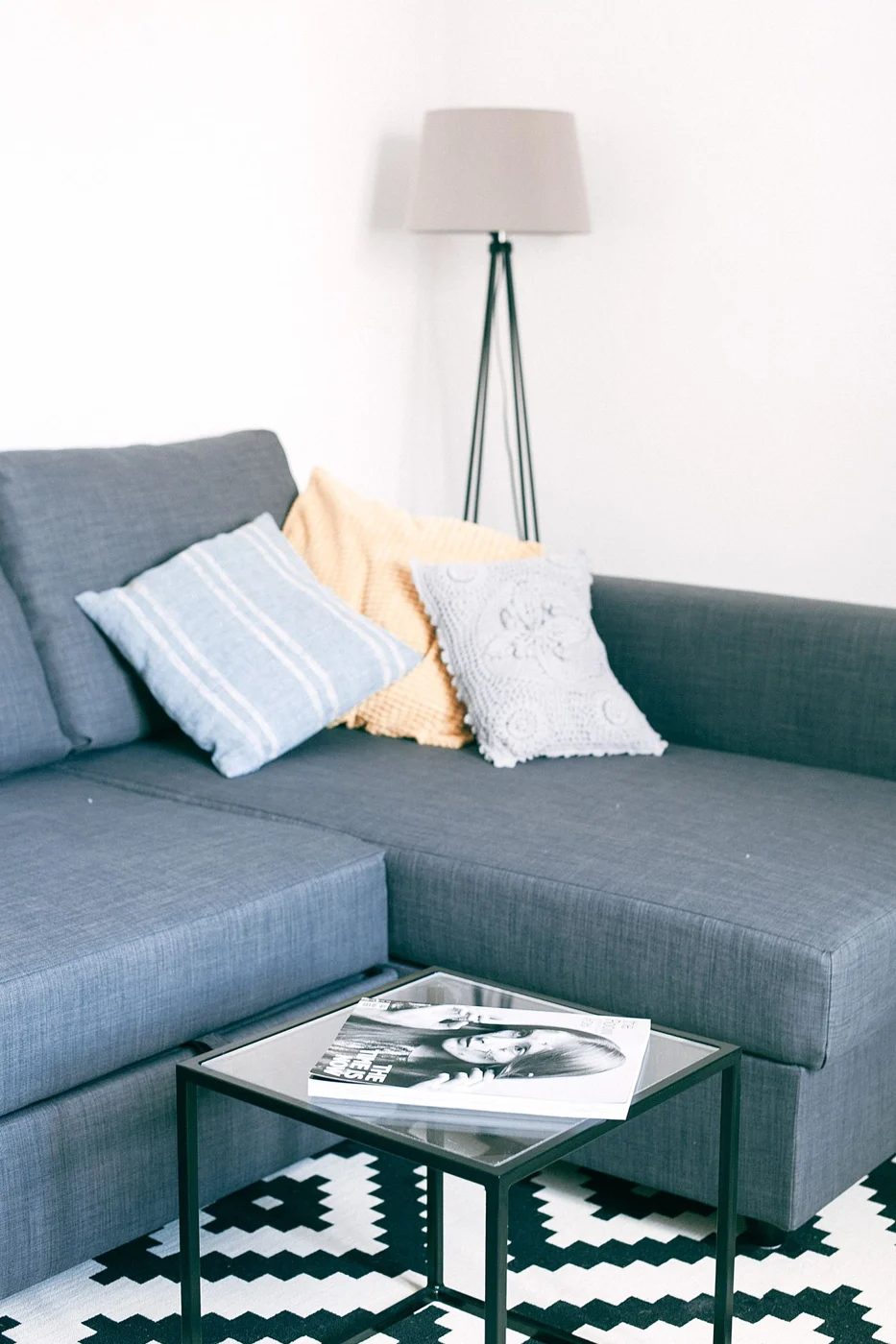 Sofa facing a square coffee table on a rug