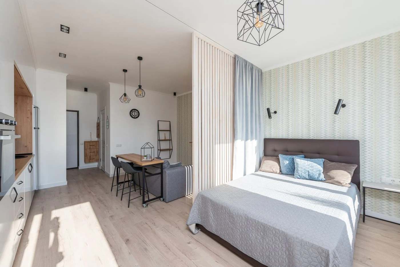 Bed and sofa in an open-plan studio apartment
