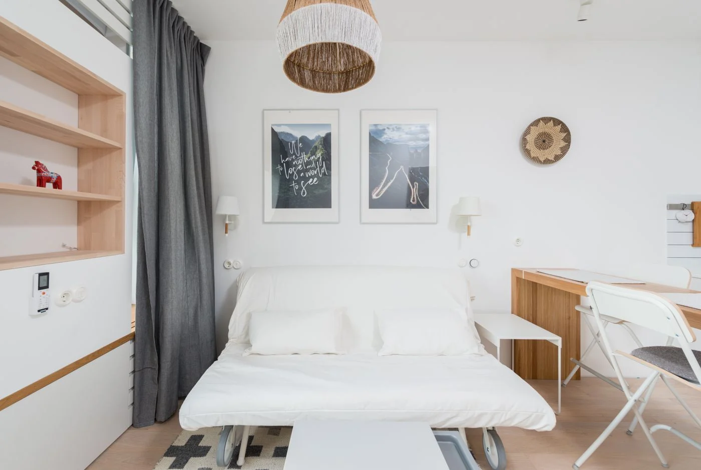 Sofa bed with cushions beside wooden furniture