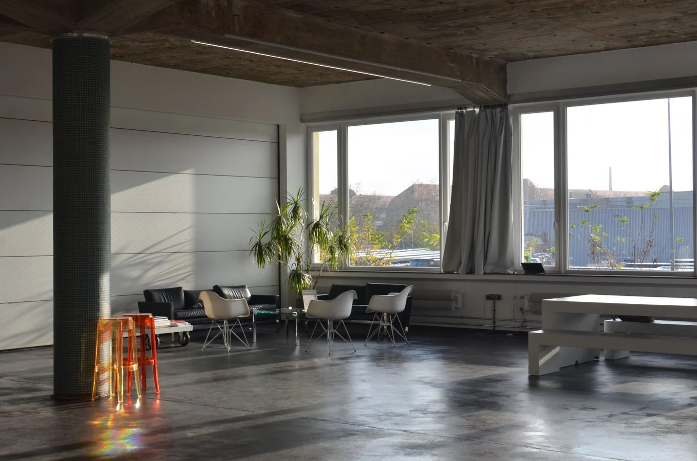 Dining table with a bench beside a living area