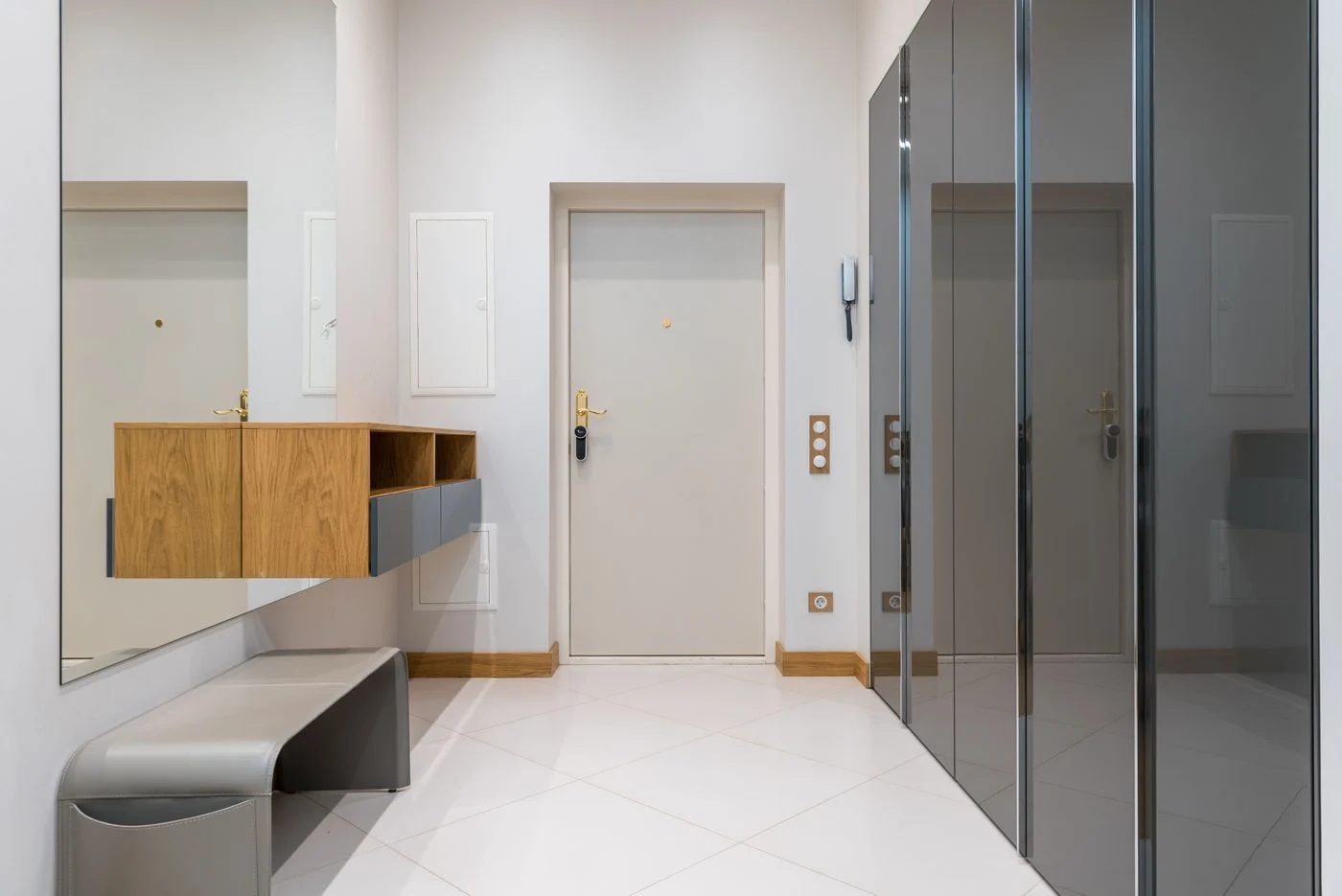 Mirrored wardrobe beside a hallway bench