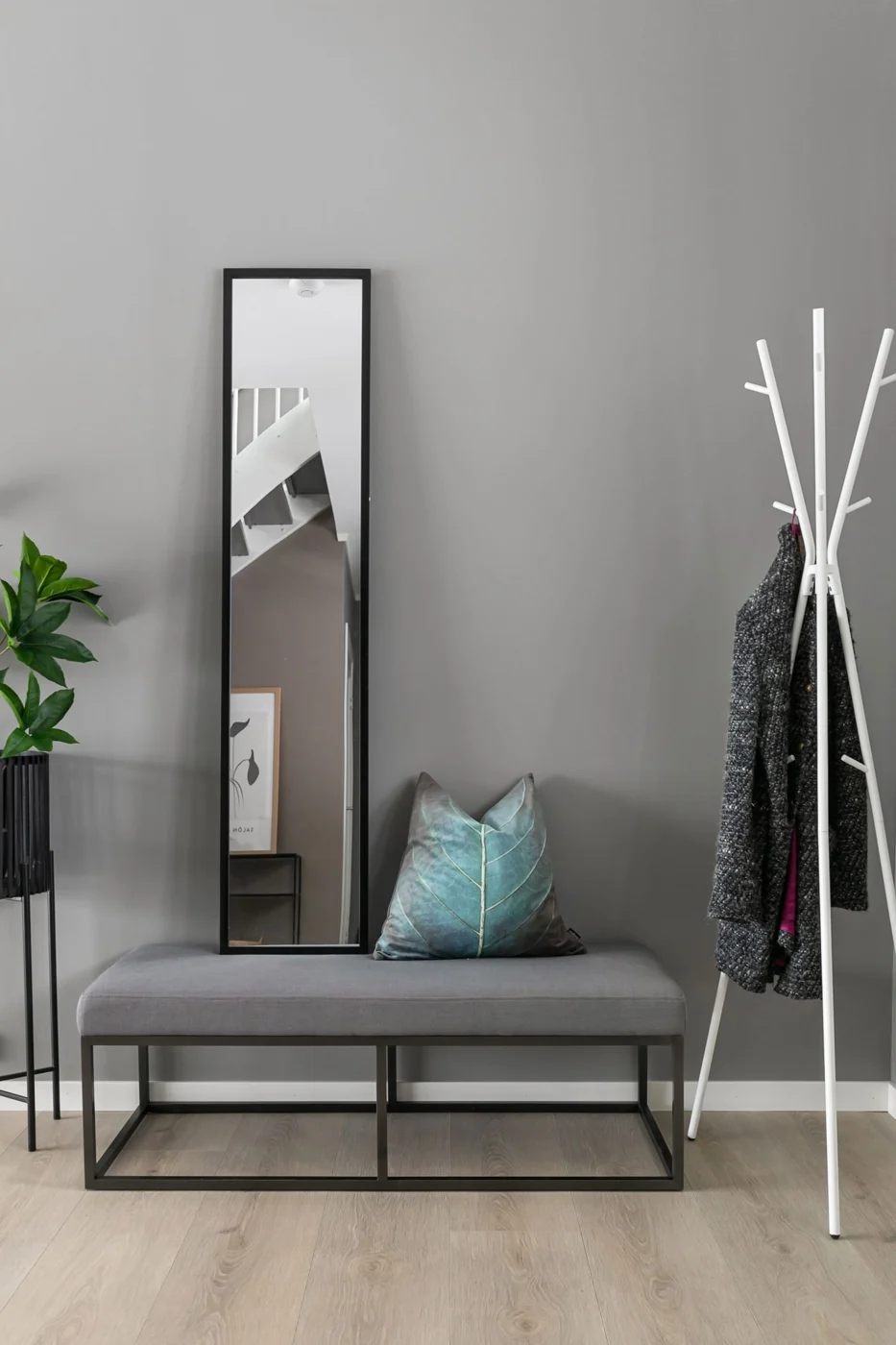 Coat rack beside a hallway bench