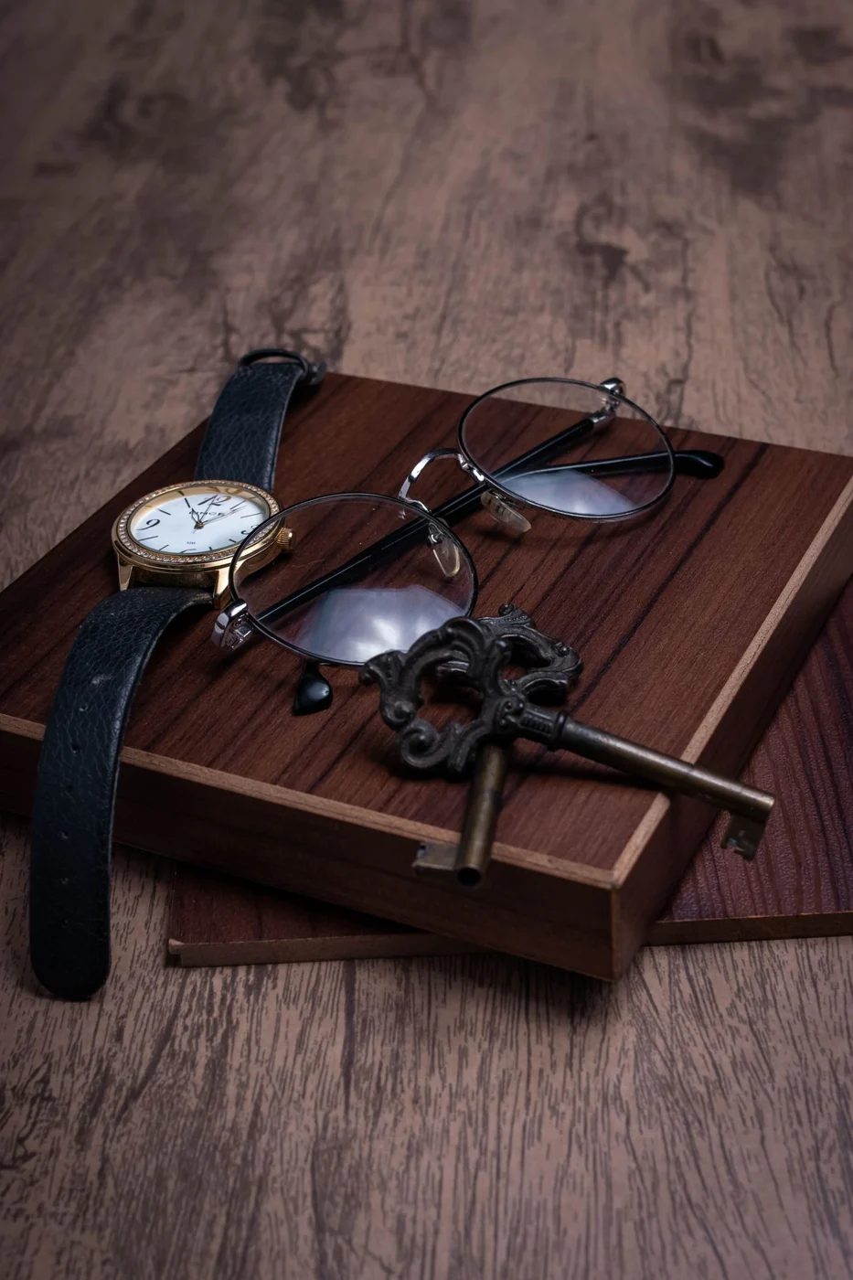 Keys and glasses on a small wooden tray