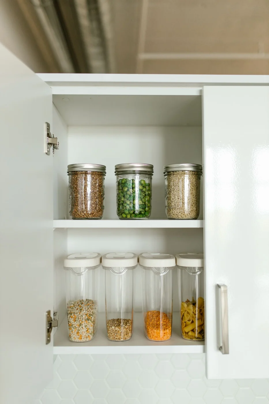 Food jars arranged inside a cupboard