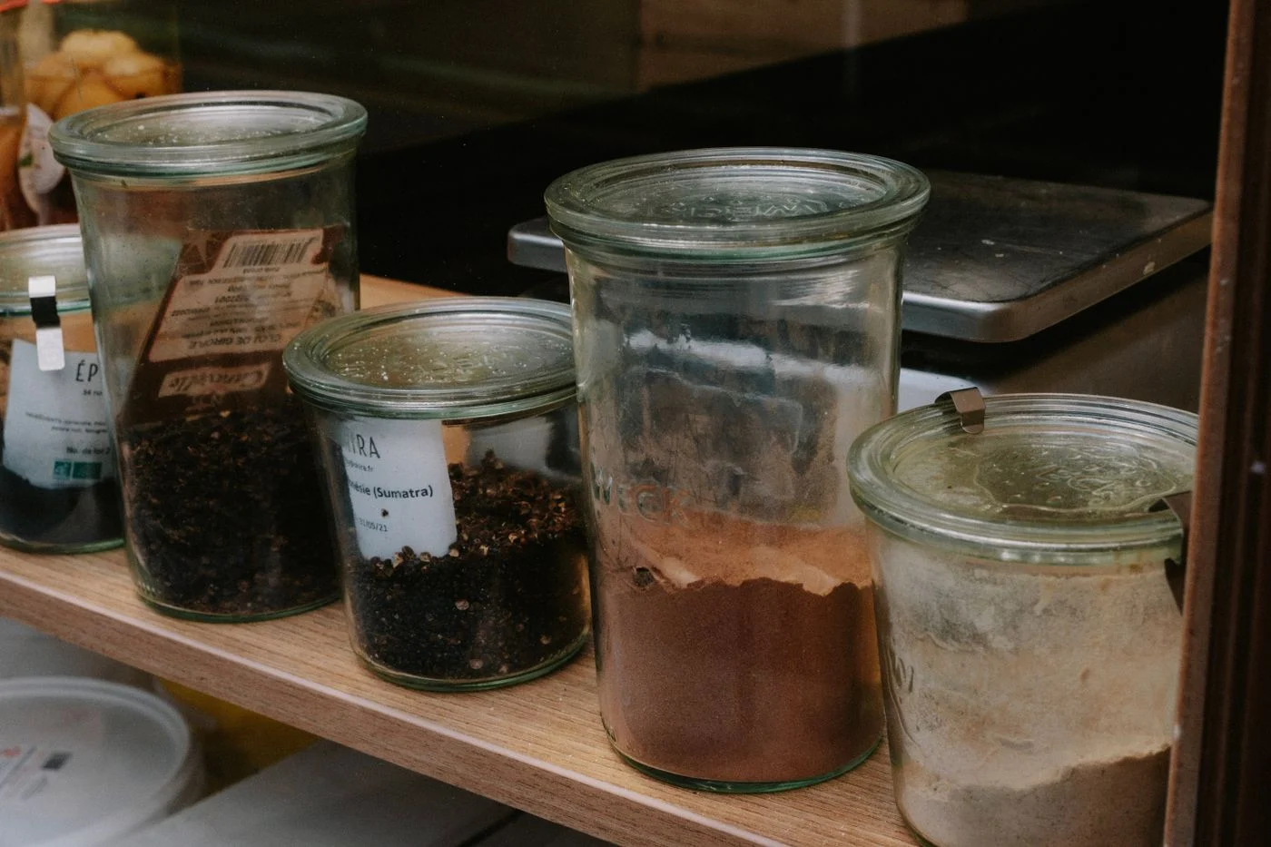 Spice jars lined up on a shelf