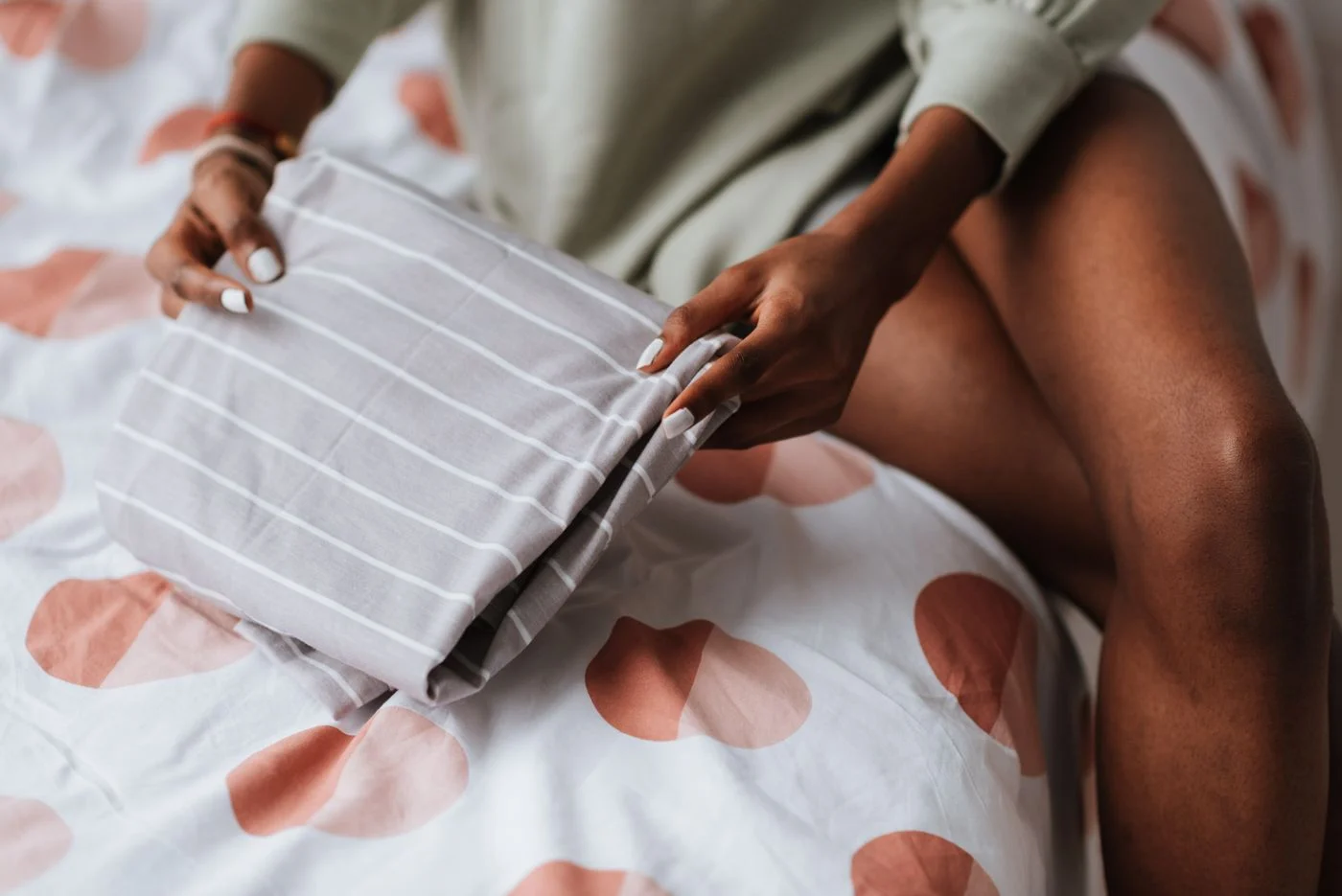 Folding clothes on a bed