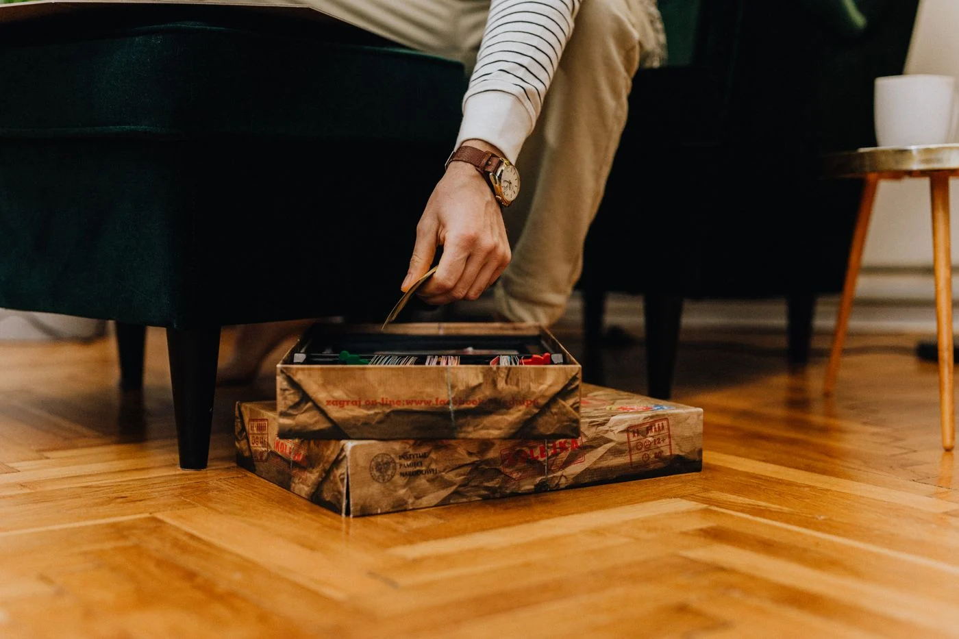 Small board-game components and cards inside their box