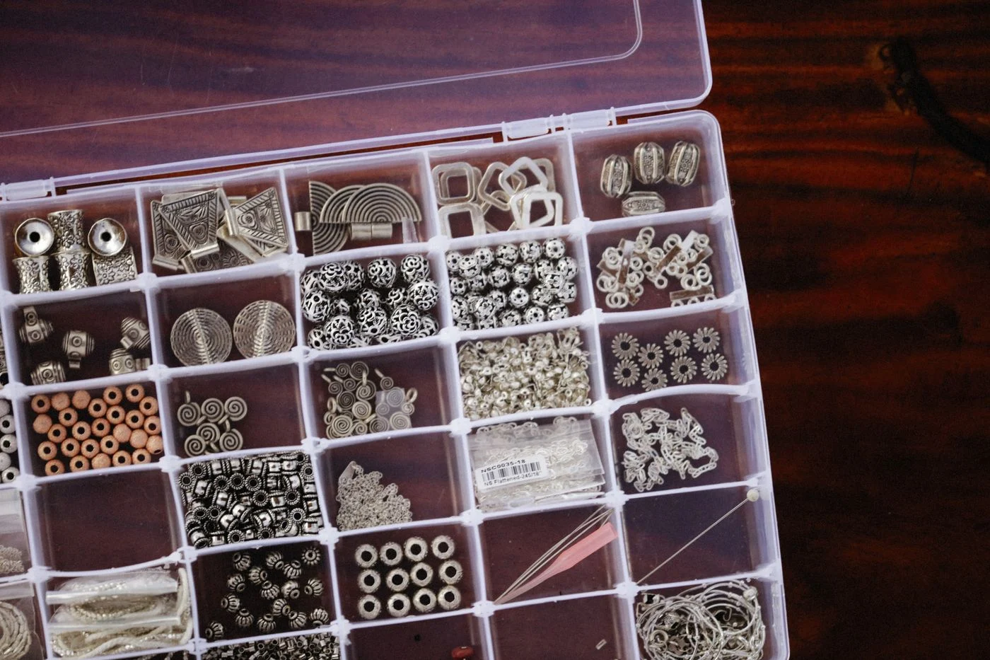 Small beads sorted in a divided storage box