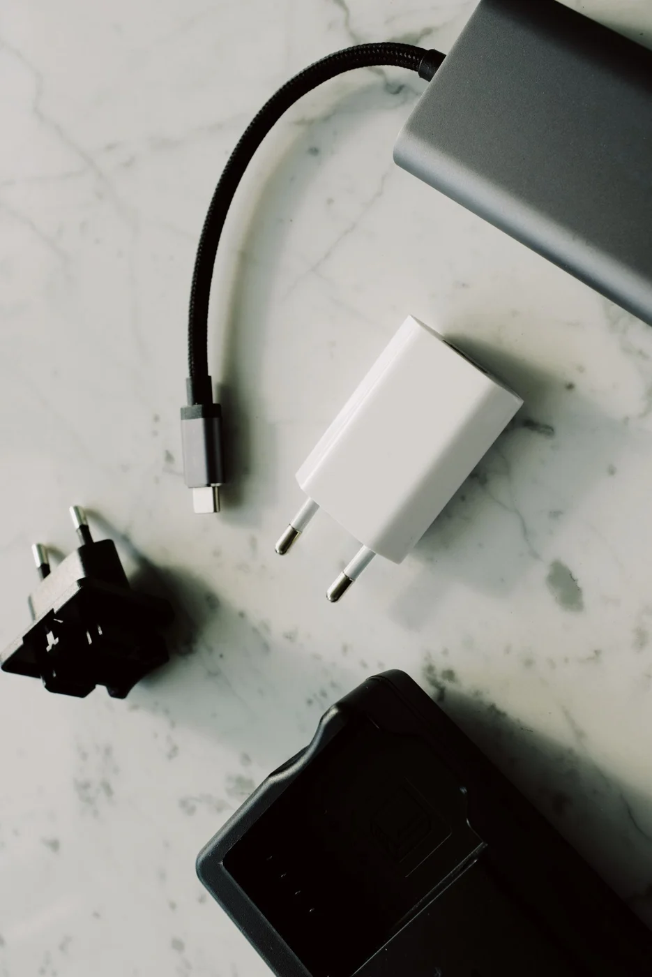 Charging cables and adapters arranged on a table