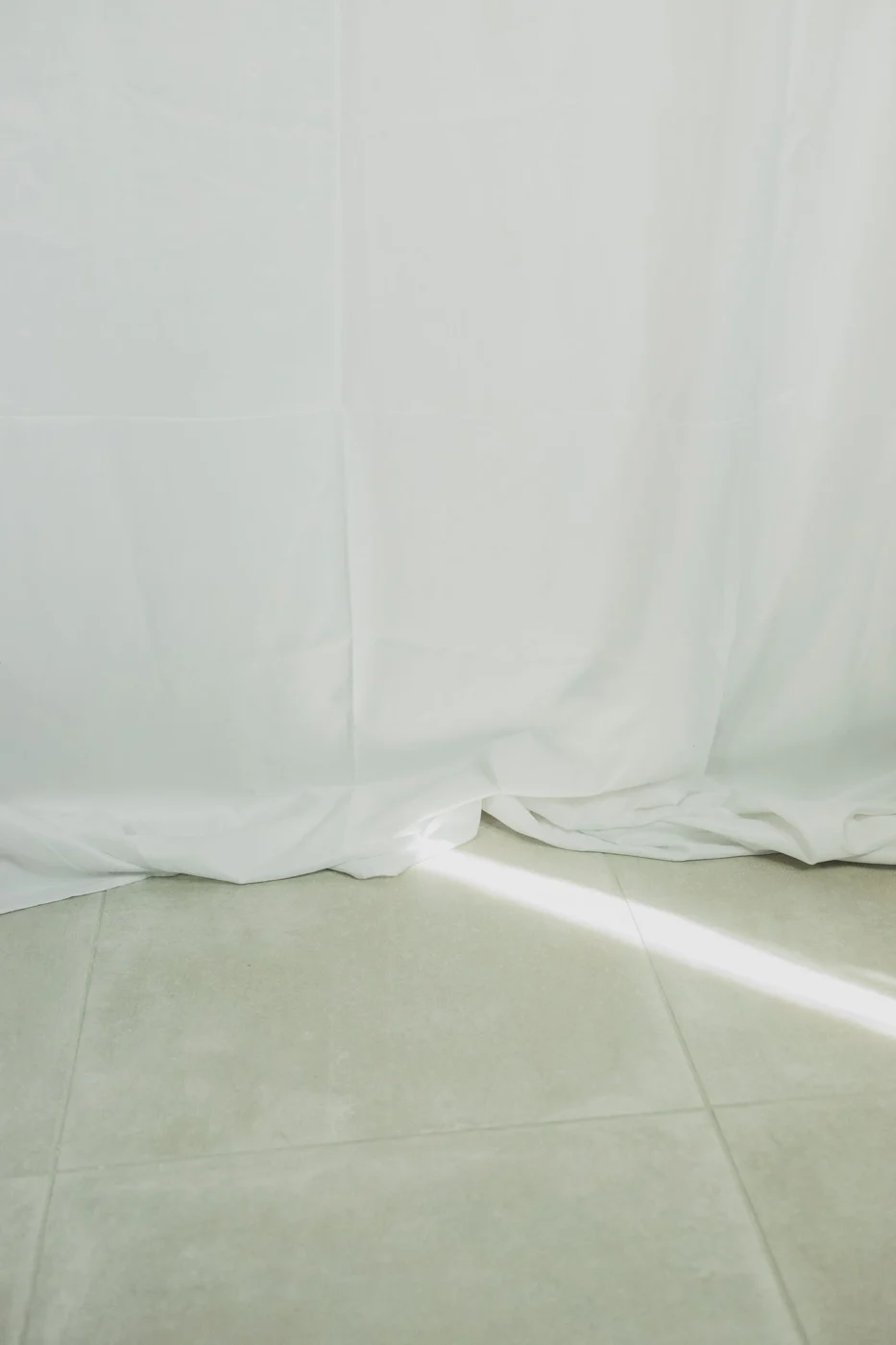 Long white curtains meeting the floor