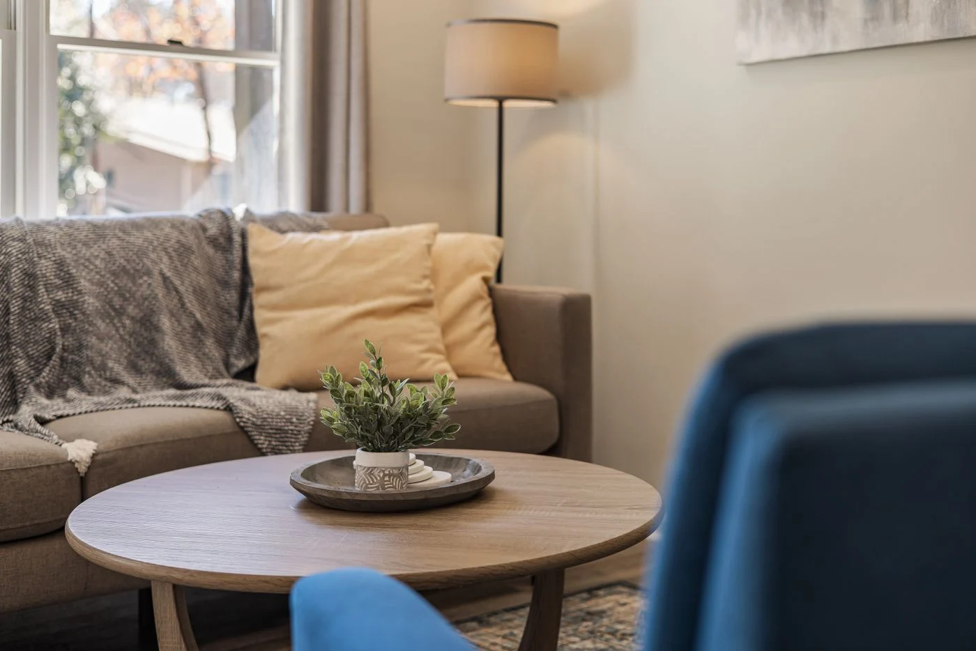 Rug beneath a seating group with round coffee table