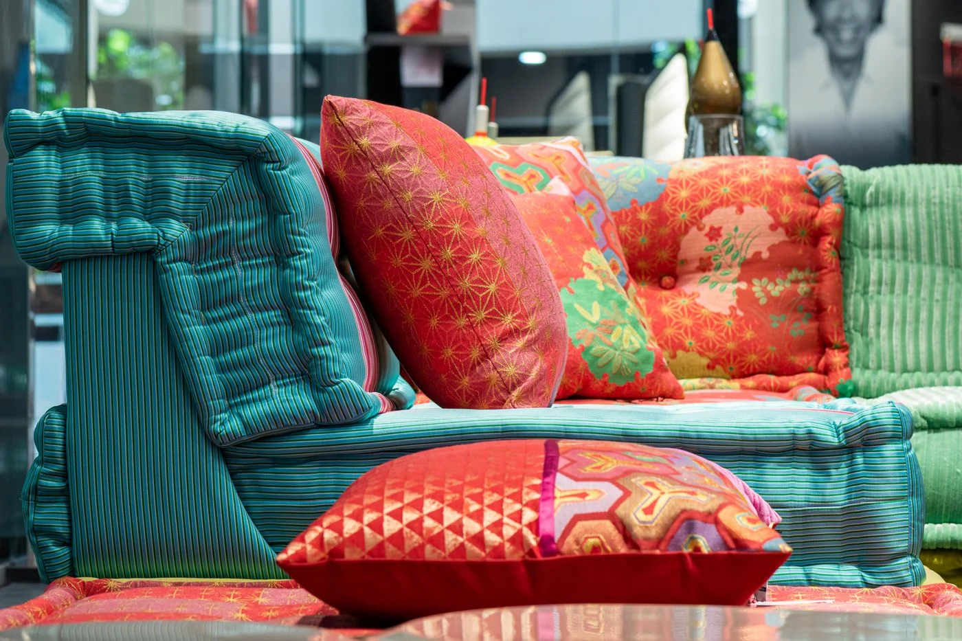 Several coloured cushions arranged on a sofa
