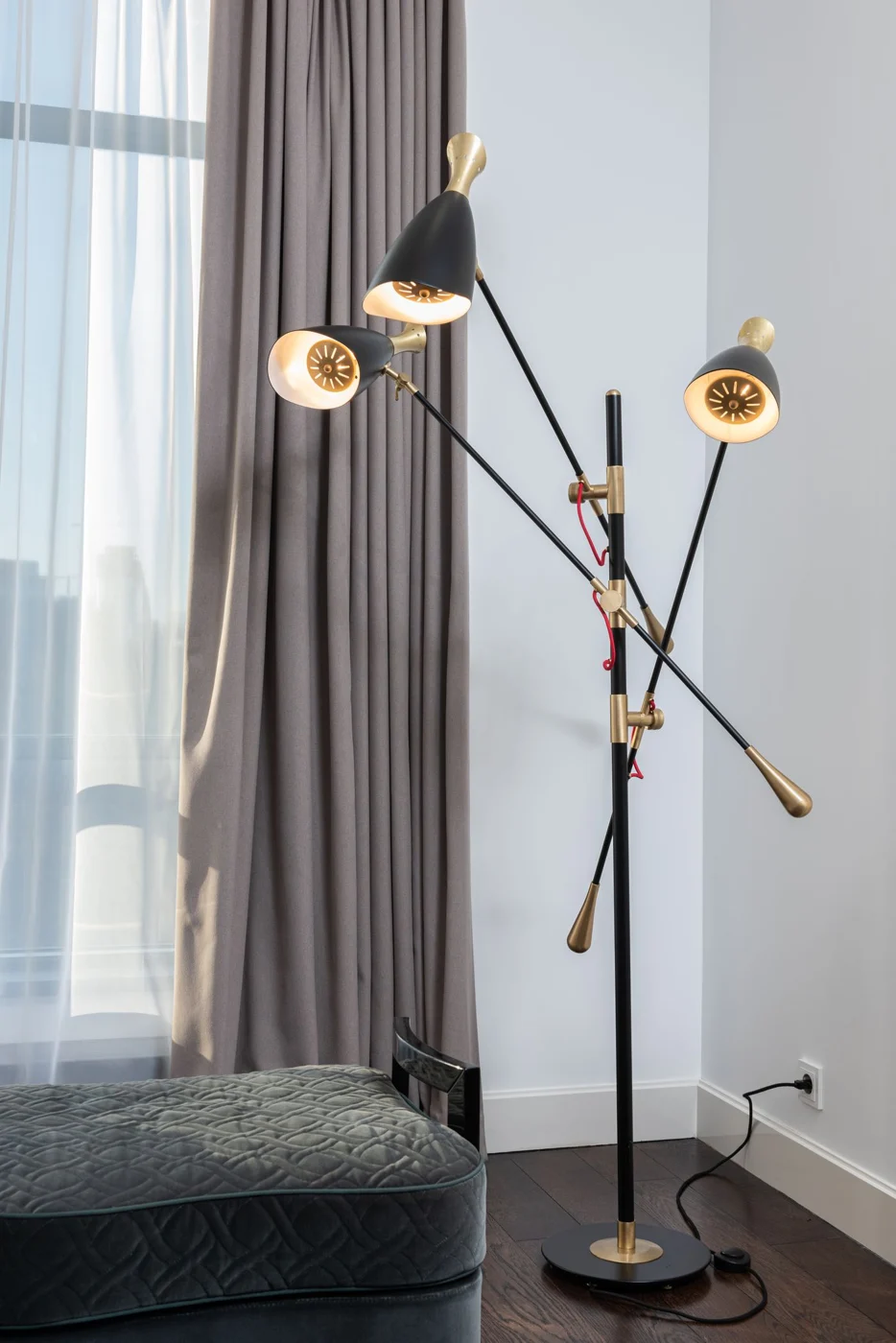 Freestanding lamps arranged beside curtains