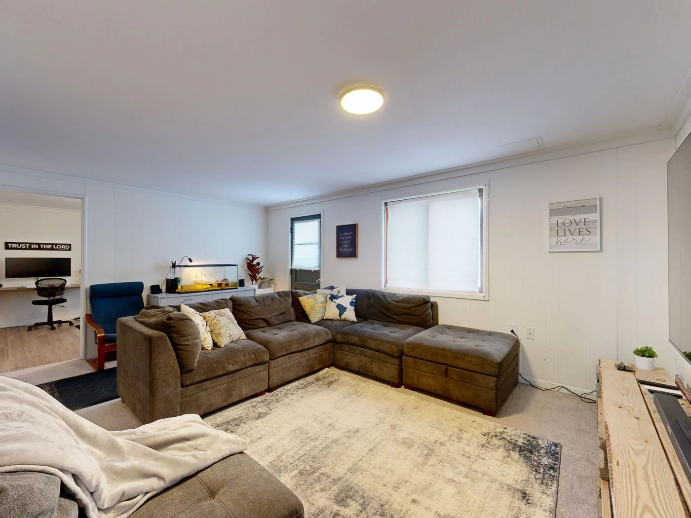 Home workspace beside a living room sofa