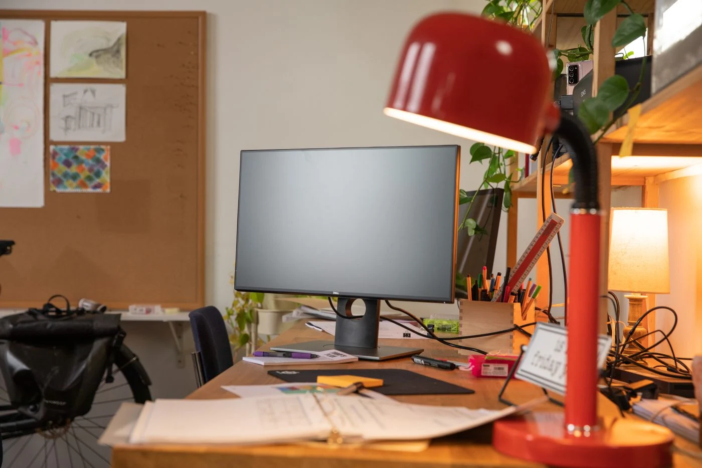 Adjustable desk lamp beside a computer screen