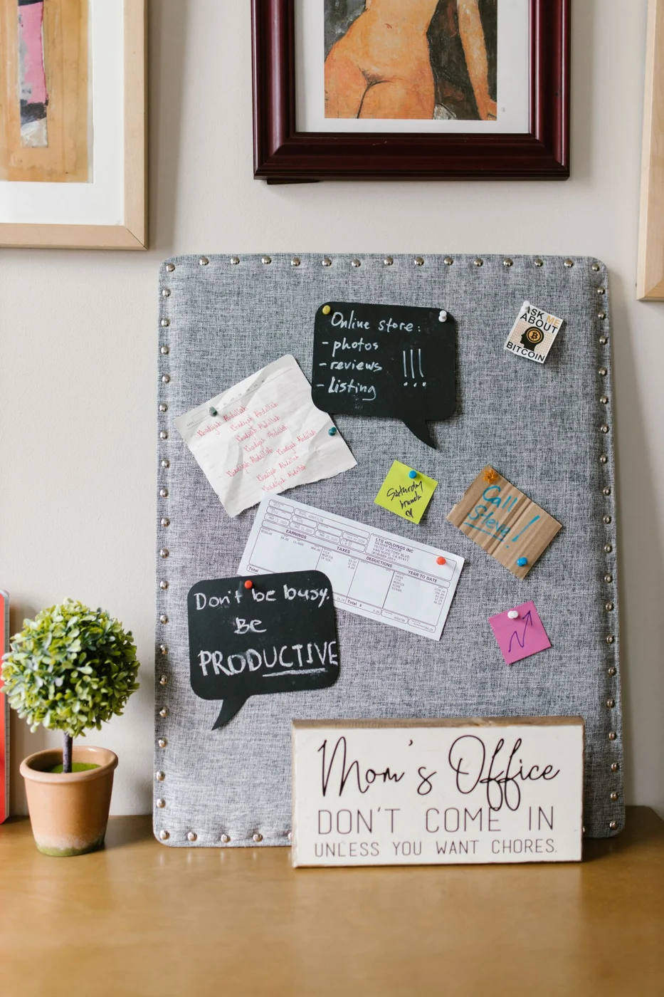 Notes pinned to a fabric noticeboard