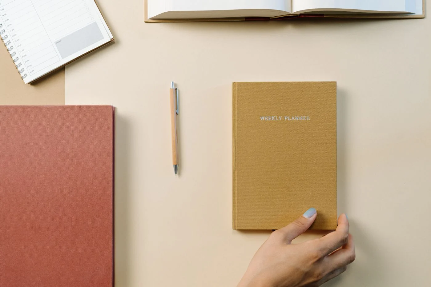 Notebook and weekly planner on a desk