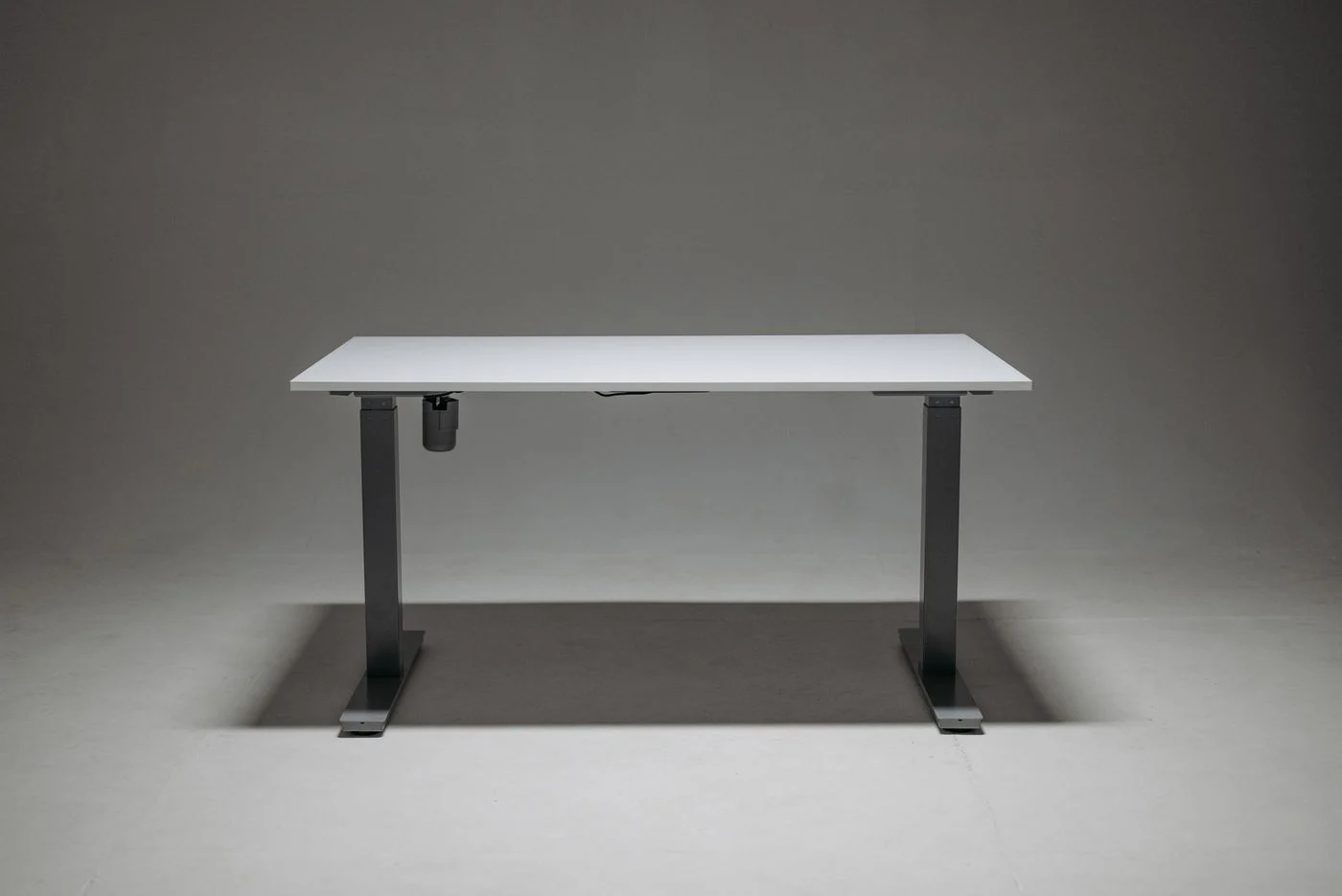 Height-adjustable desk with a compact top