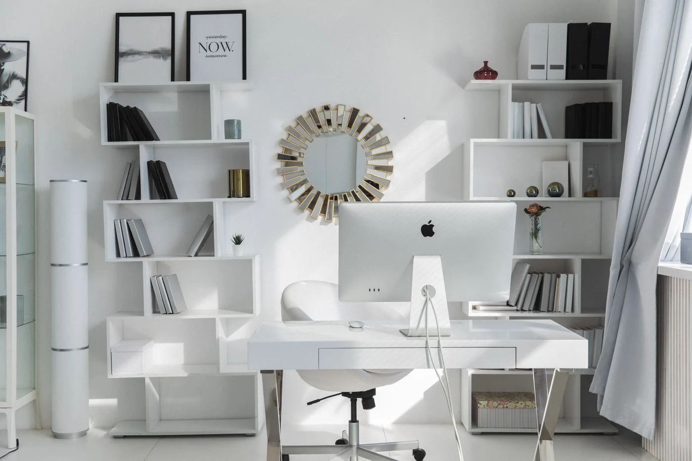 White desk and uncluttered shelves in a home office