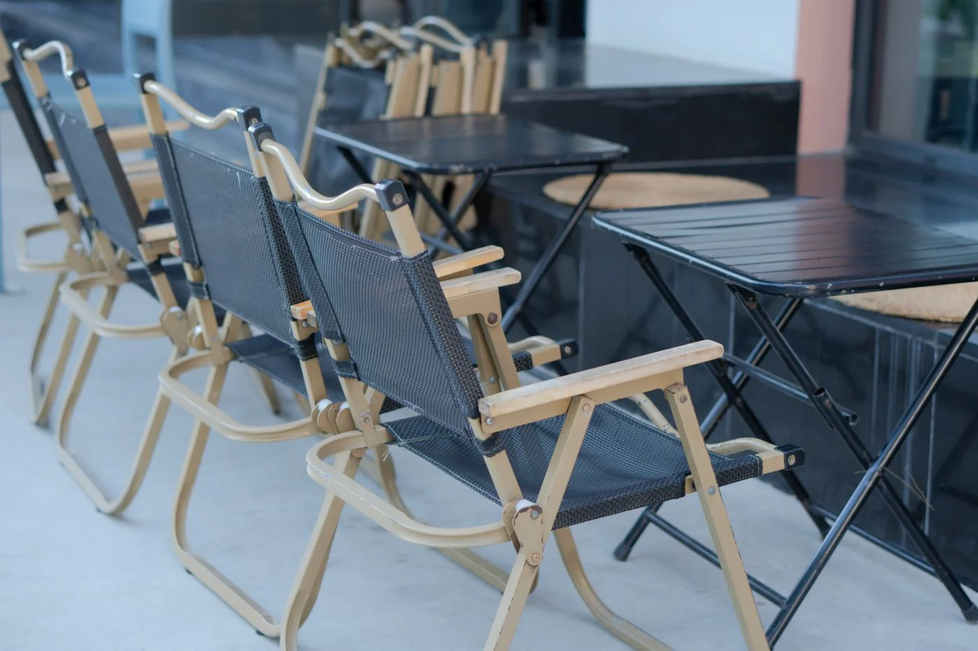 Folding chairs beside folding outdoor tables