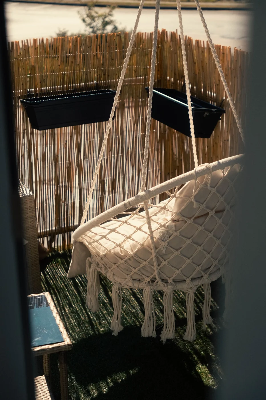 Balcony seating beside a bamboo privacy screen