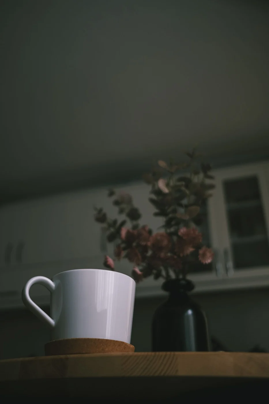 Ceramic cup on a coaster on a wooden table