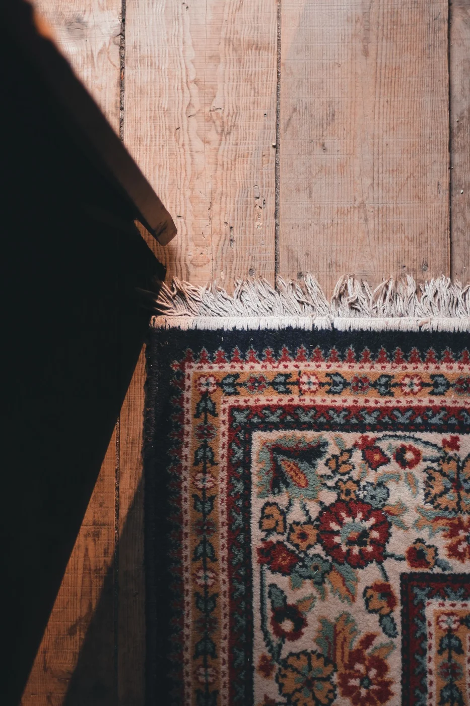 Rug fringe and edge on a wooden floor